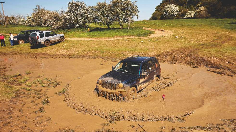 Jeep cherokee driving through mud